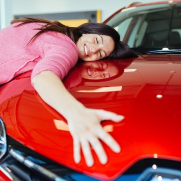 car insurance root insurance app features happy woman hugging red car